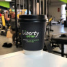 Custom printed paper cup with black lid with 'Liberty Gym' logo