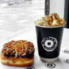 Customised black double wall paper cup with 'Black box donuts' logo used to serve a cup of hot cocoa